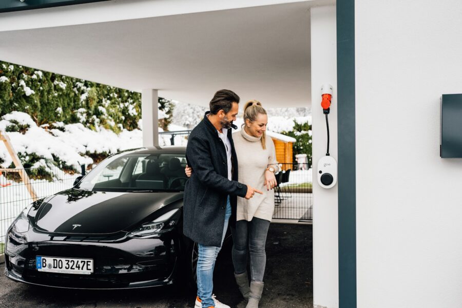 Family inspecting new electric car dealership