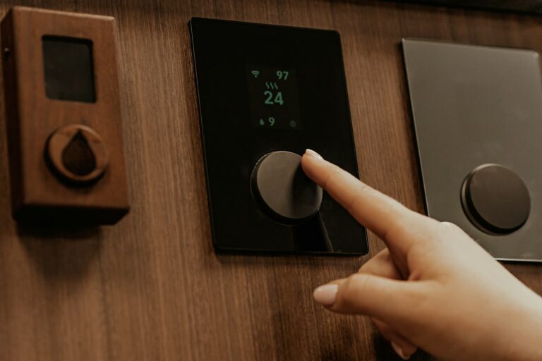Driver hand adjusting climate control panel
