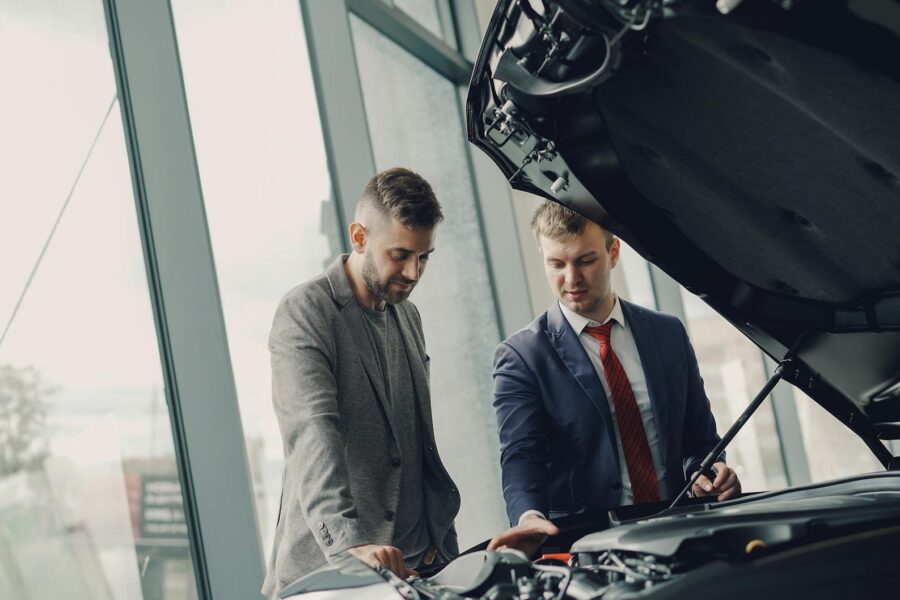 Electric car buyer inspecting vehicle interior dealership